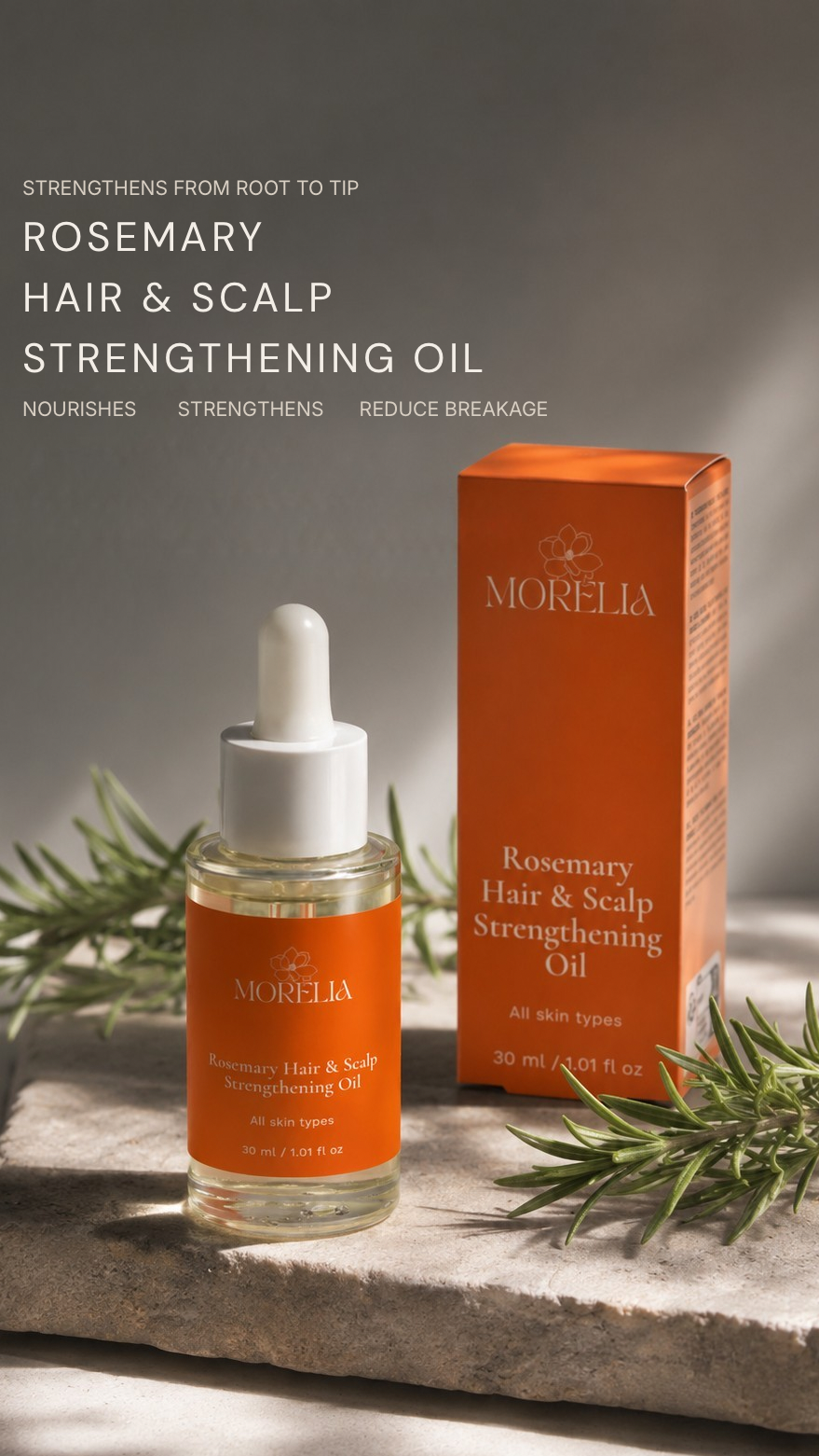 A bottle of Morelia Rosemary Hair & Scalp Strengthening Oil with a white dropper cap stands next to its orange box on a stone slab, with rosemary sprigs and soft shadows in the background.